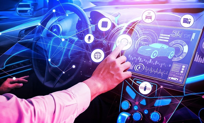 a hand interacting with a futuristic infotainment system inside a car